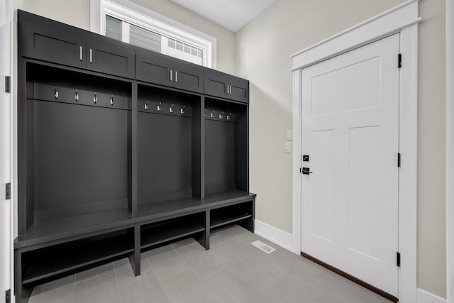 mudroom with light tile patterned floors and baseboards