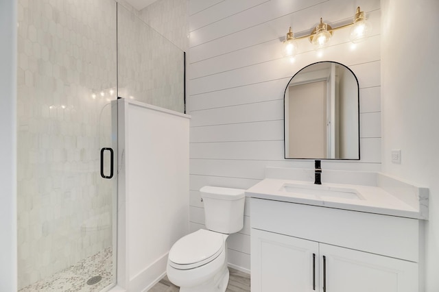 full bath with vanity, a shower stall, and toilet