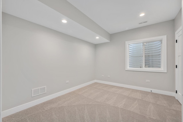 empty room featuring recessed lighting, baseboards, visible vents, and light carpet