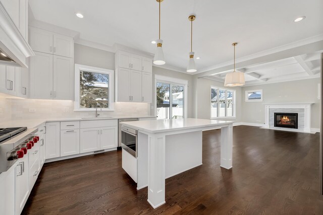 kitchen featuring premium range hood, beamed ceiling, a sink, tasteful backsplash, and dark wood finished floors