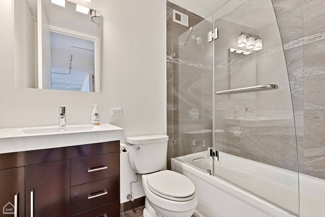 bathroom with visible vents, vanity, toilet, and bath / shower combo with glass door