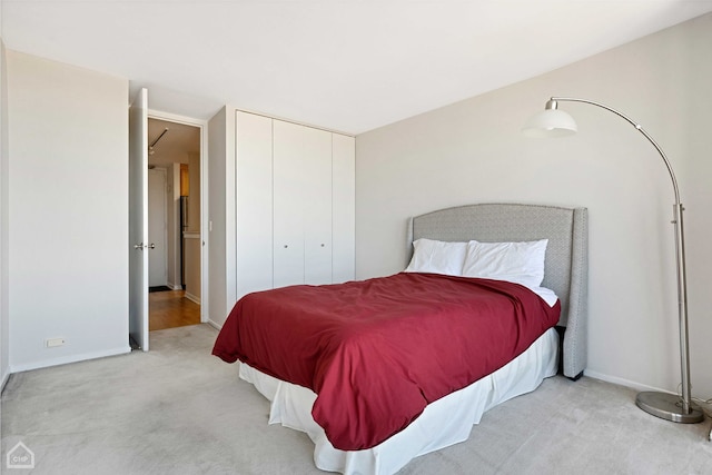 bedroom with a closet, baseboards, and carpet floors