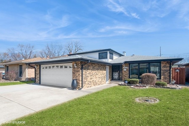 mid-century home featuring brick siding, a garage, driveway, and a front lawn