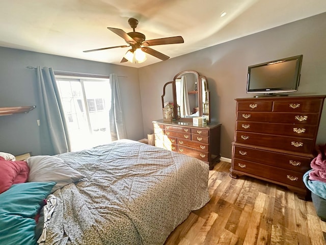 bedroom with ceiling fan and light wood-style floors