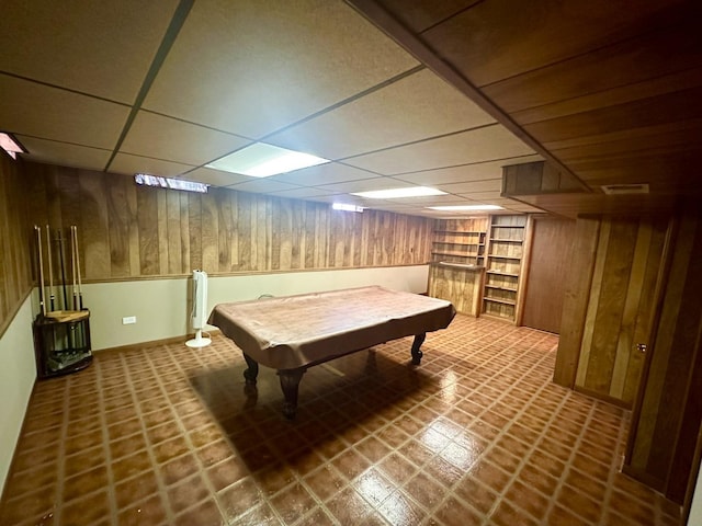 playroom featuring built in features, a drop ceiling, wooden walls, and visible vents