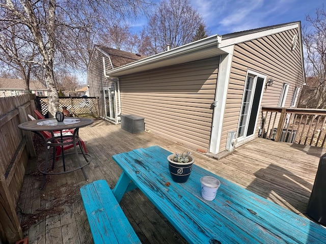 wooden terrace featuring fence