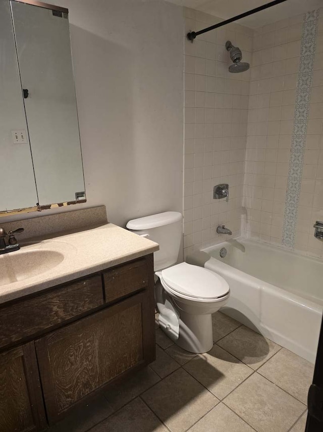 bathroom featuring tile patterned flooring, toilet, vanity, and  shower combination