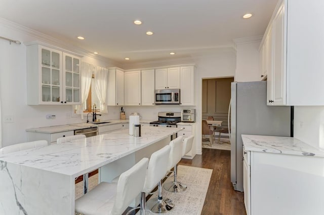 kitchen with a sink, dark wood-type flooring, white cabinetry, and stainless steel appliances