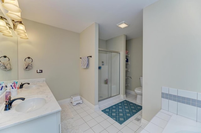 full bath with tile patterned flooring, toilet, and a sink