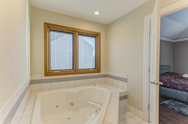 ensuite bathroom featuring baseboards, a whirlpool tub, and ensuite bathroom