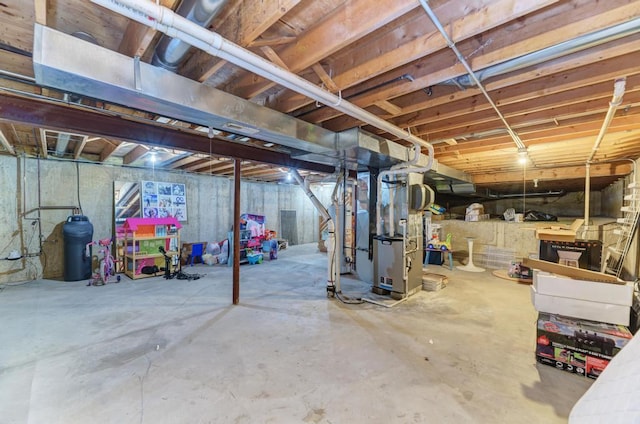 unfinished basement featuring heating unit