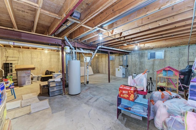 basement featuring electric panel and gas water heater