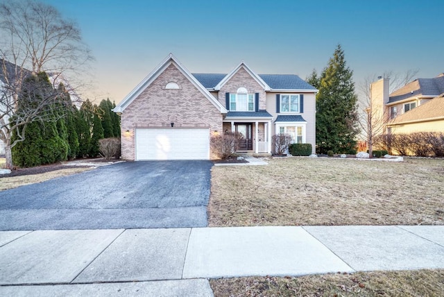 view of front of house with brick siding, driveway, and an attached garage