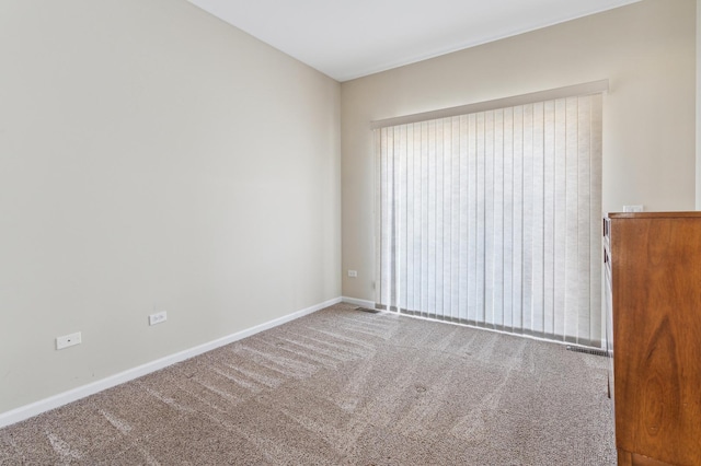 unfurnished room featuring baseboards and carpet