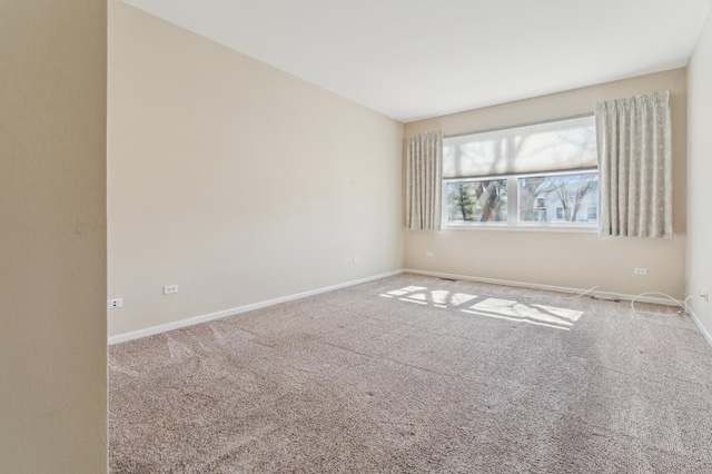 carpeted spare room with baseboards