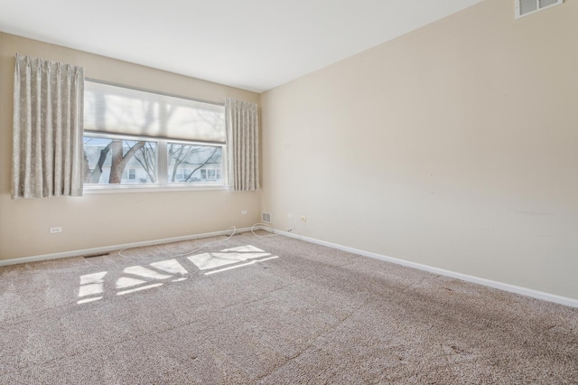 carpeted empty room with visible vents and baseboards