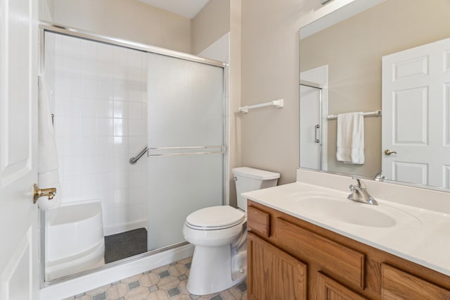 bathroom featuring vanity, toilet, and a shower