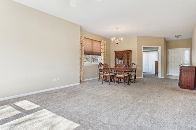 dining space with baseboards, light carpet, and a chandelier