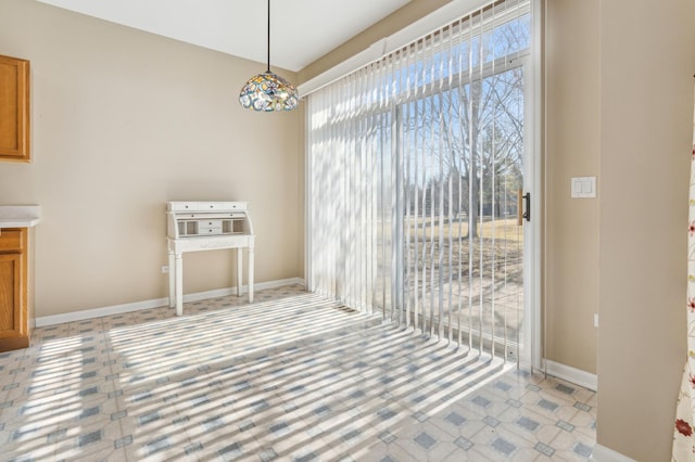 unfurnished dining area with baseboards