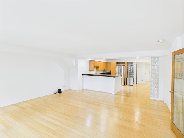 unfurnished living room featuring recessed lighting and light wood finished floors