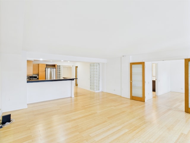 unfurnished living room with light wood-type flooring and recessed lighting