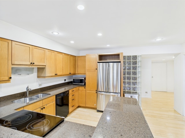 kitchen featuring recessed lighting, appliances with stainless steel finishes, stone counters, and a sink