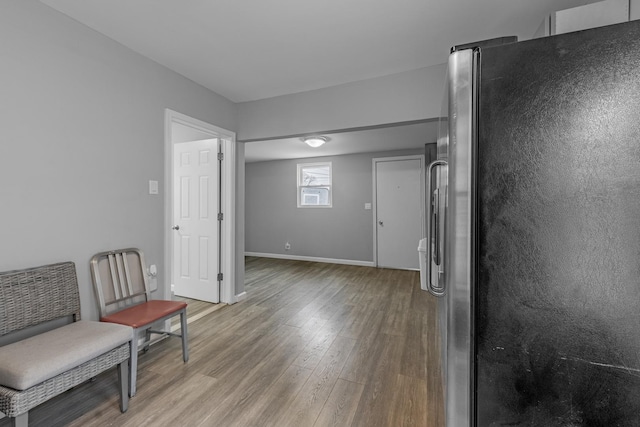 sitting room with light wood-type flooring and baseboards