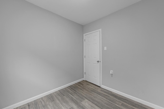 empty room with wood finished floors and baseboards