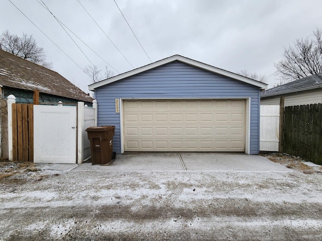 detached garage featuring fence