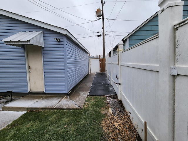 view of side of home featuring fence