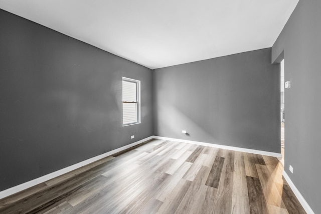 unfurnished room with wood finished floors and baseboards