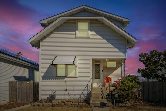 traditional-style home featuring fence