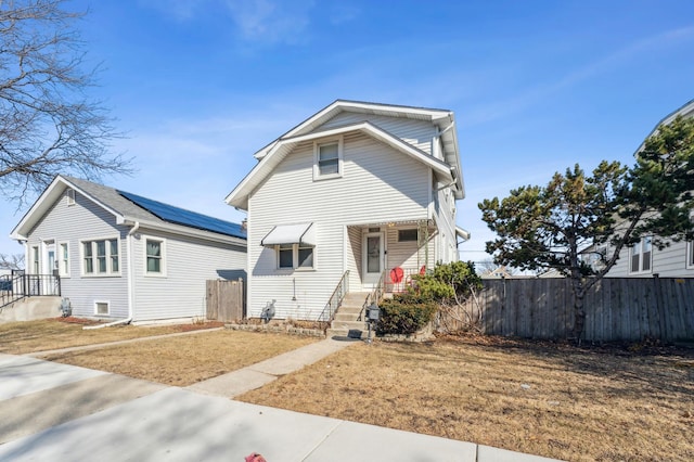 view of front of home featuring fence