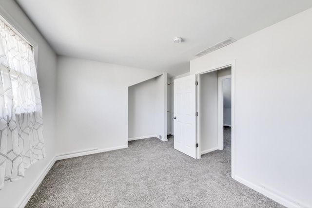 unfurnished bedroom featuring visible vents, carpet floors, and baseboards