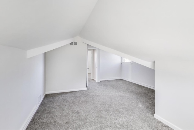 bonus room featuring visible vents, carpet floors, baseboards, and vaulted ceiling