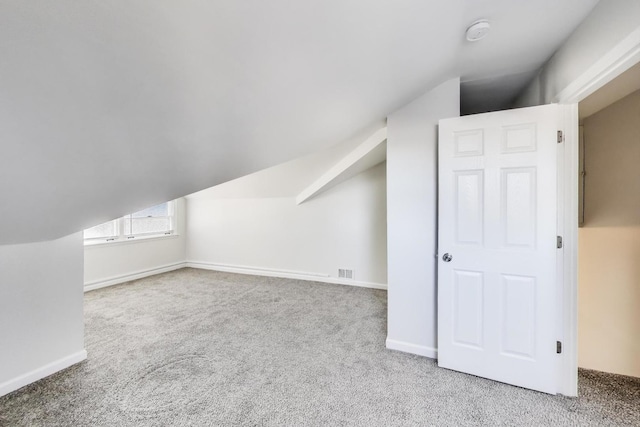 bonus room with baseboards, visible vents, carpet floors, and lofted ceiling