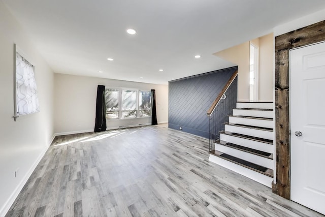 interior space featuring recessed lighting, stairway, baseboards, and wood finished floors