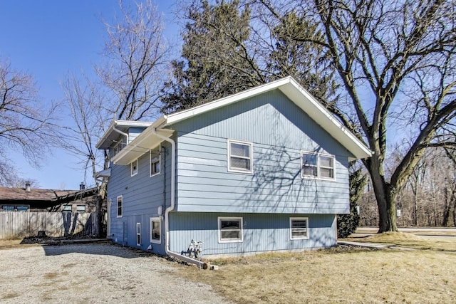 view of side of home featuring fence