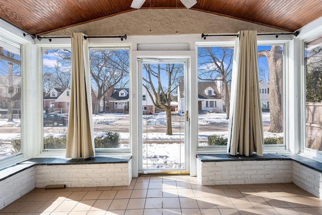 unfurnished sunroom with wood ceiling and vaulted ceiling