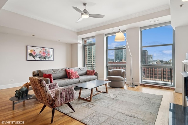 living room with a view of city, wood finished floors, visible vents, and ornamental molding