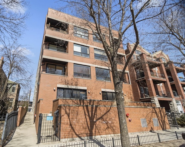 view of building exterior with fence