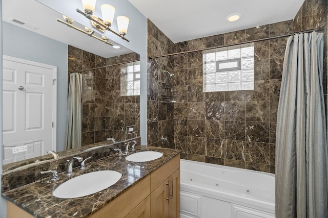 bathroom with double vanity, visible vents, a combined bath / shower with jetted tub, and a sink