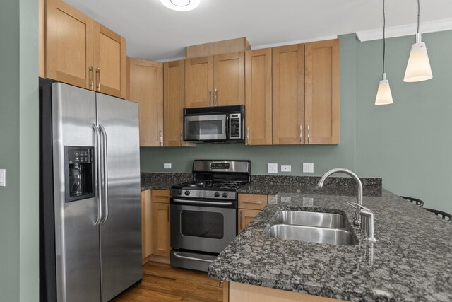 kitchen with dark wood-type flooring, stainless steel refrigerator with ice dispenser, dark countertops, a peninsula, and baseboards