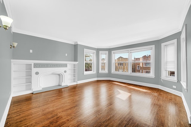 unfurnished living room with a fireplace, crown molding, baseboards, and wood finished floors