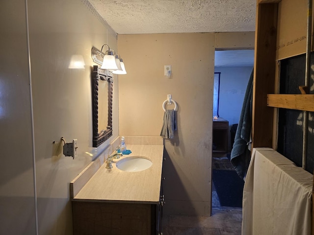 bathroom with a textured ceiling and vanity