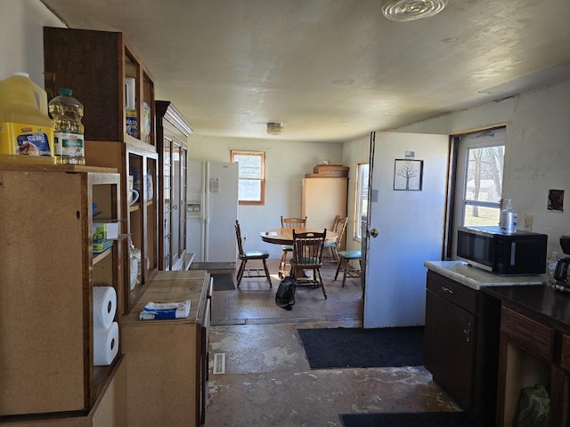 kitchen featuring white refrigerator with ice dispenser