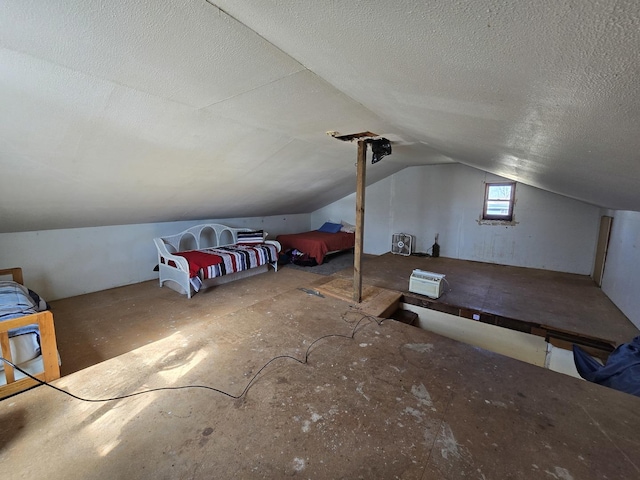 bonus room with vaulted ceiling and a textured ceiling