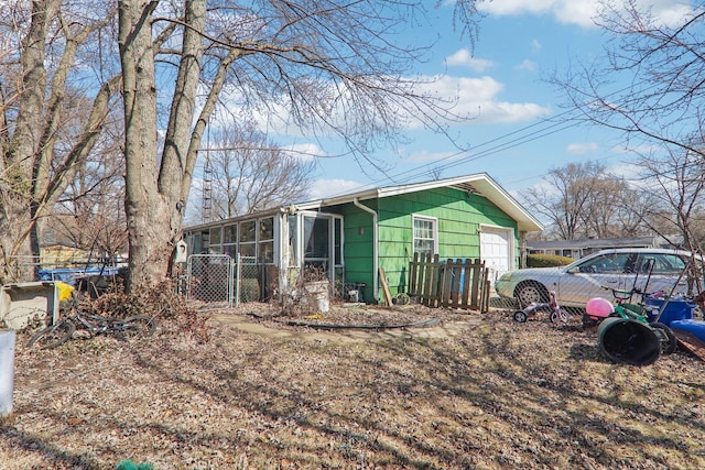 exterior space featuring fence and a sunroom