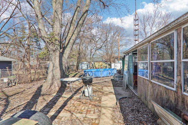 view of yard featuring a fenced in pool, a patio, and fence