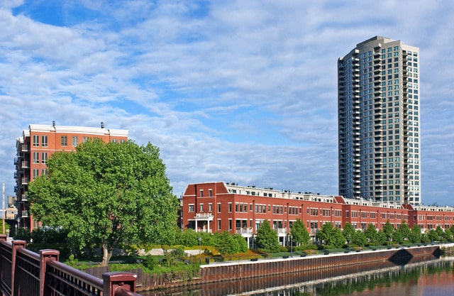 view of building exterior with a water view and a city view